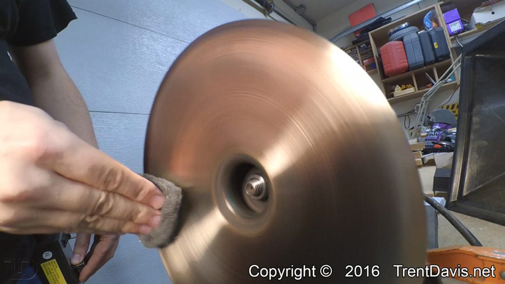 Fig. 6 - Finishing up the underside of the first cymbal with some 0000 steel wool.