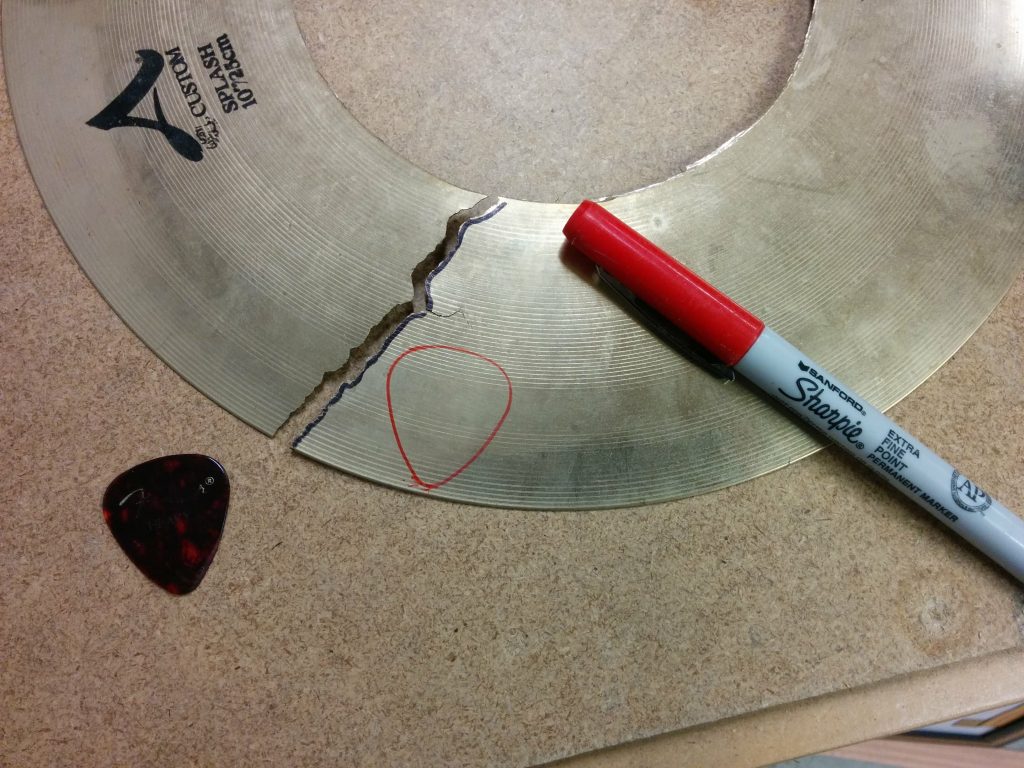 Outline of the pick traced on the cymbal.