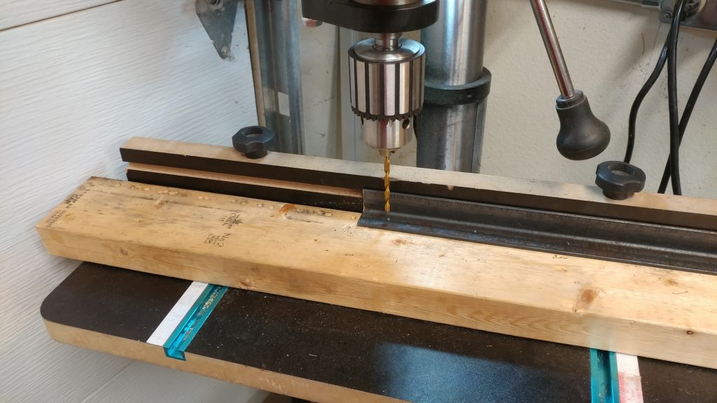 Setting up the drill press for drilling through the angle iron.
