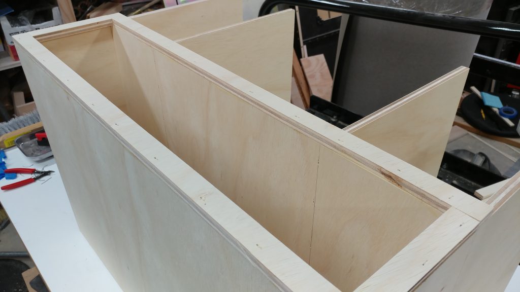 The framing for the bottom drawer opening are glued and nailed in place.